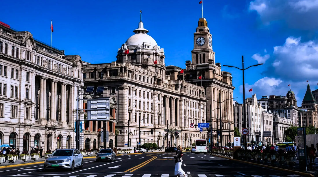 Historic Bund waterfront with European architecture and clock tower under blue sky in Shanghai — annual physical exam china